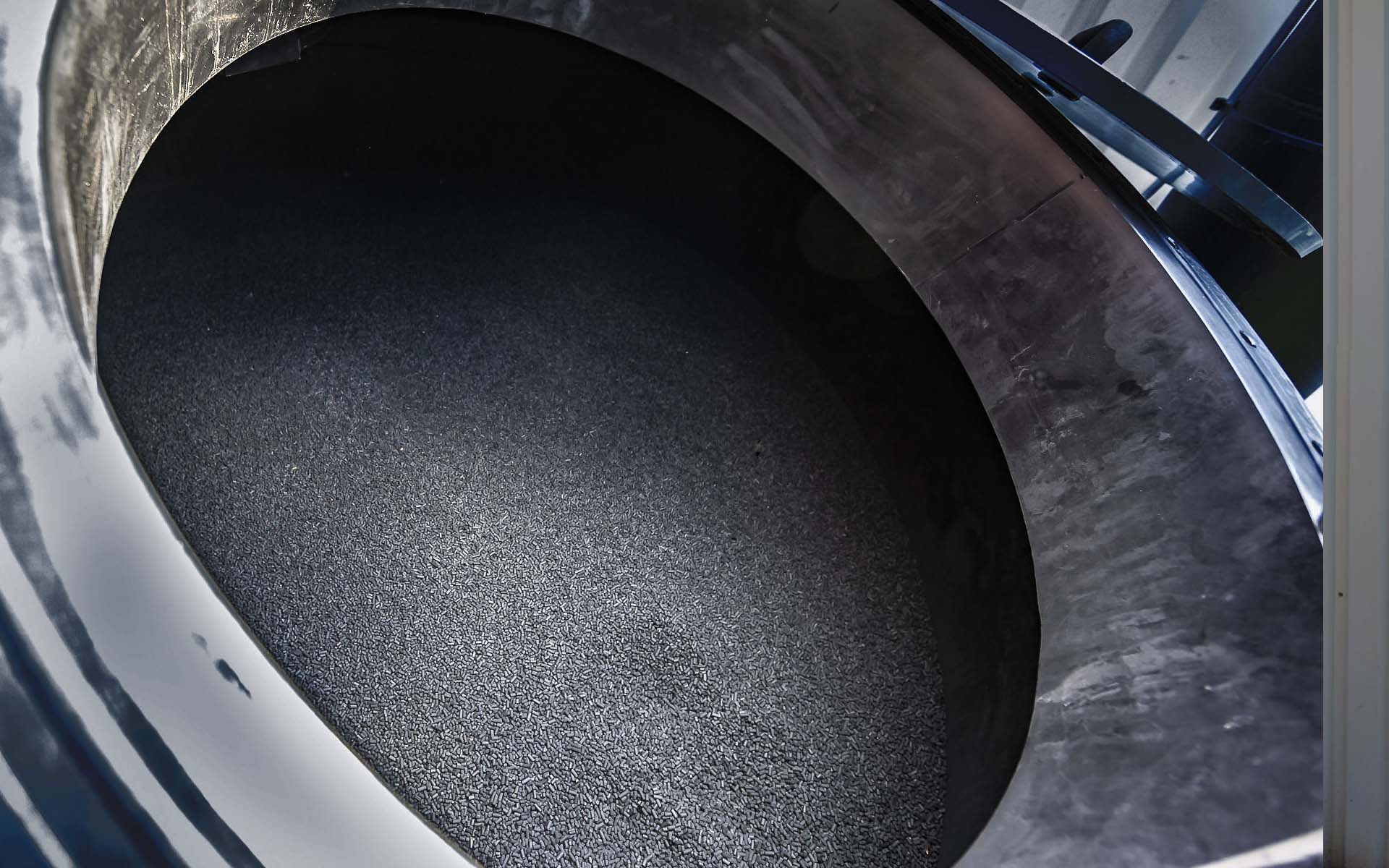 The view through the manhole of a large activated carbon filter at a waste disposal company in southern Lower Austria shows the activated carbon pellets